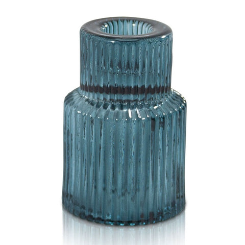 Blue textured glass candle holder on a white background