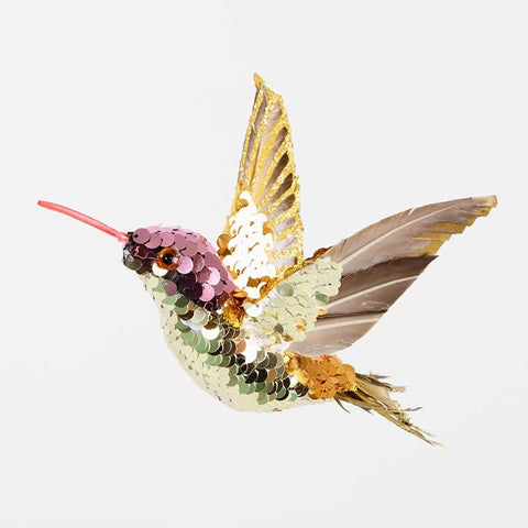 Sequined hummingbird decoration on a white background