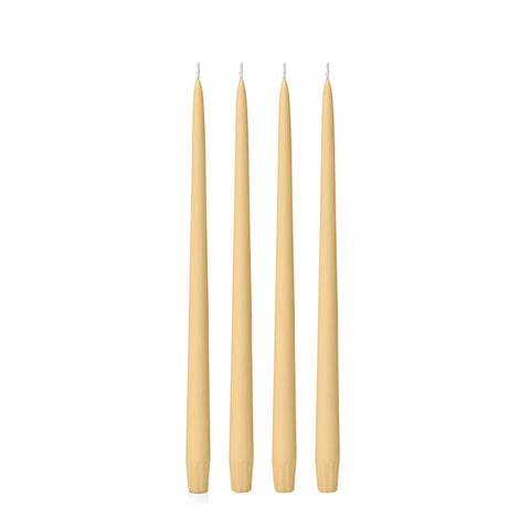 Four gold 25cm candles on a white background