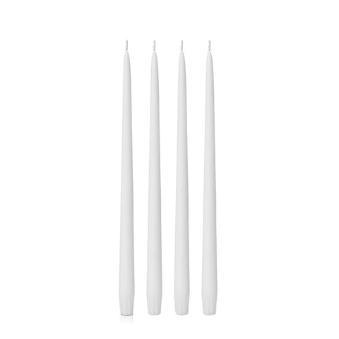 Four white candles 25cm of varying lengths on a white background