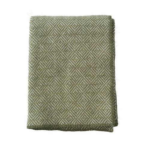 Folded green textured blanket on a white background