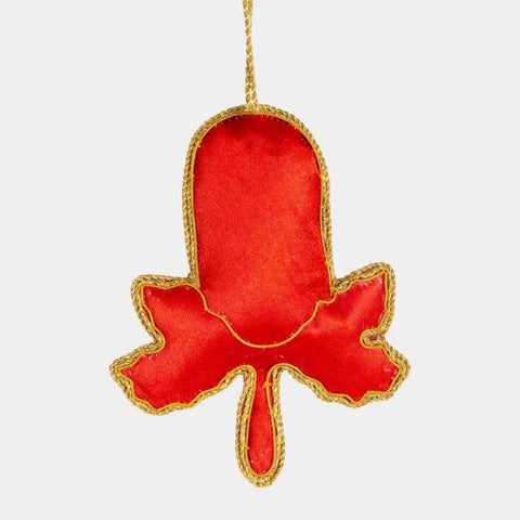 Decorative ornament shaped like a flower with red and green details on a white background
