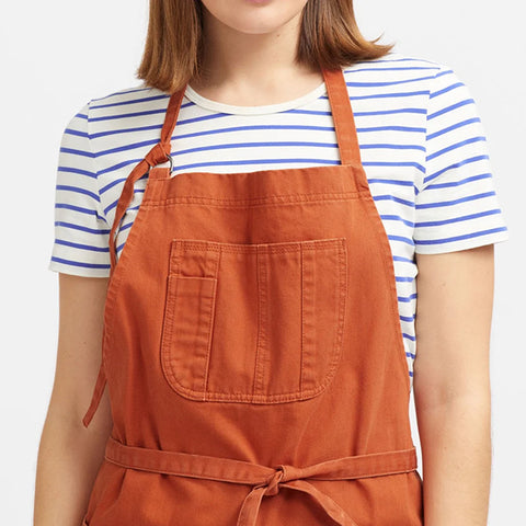Person wearing an orange apron on a white background Boston Cotton Drill Unisex Apron Pumpkin by Cargo Crew