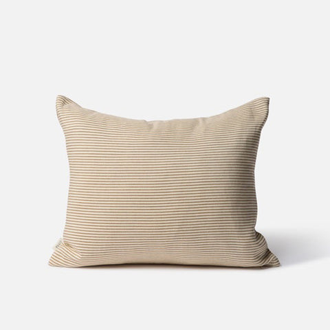 Beige striped pillow on a white background