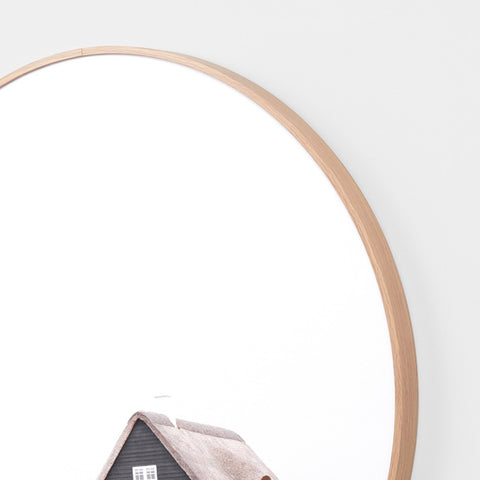 Framed artwork of a coastal house on a seaside landscape