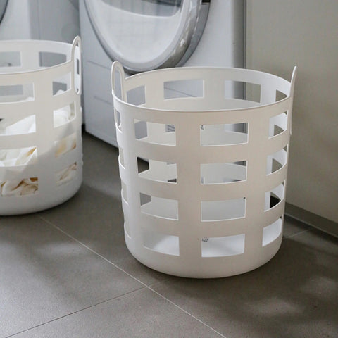 Two white laundry baskets with a grid pattern on a white background