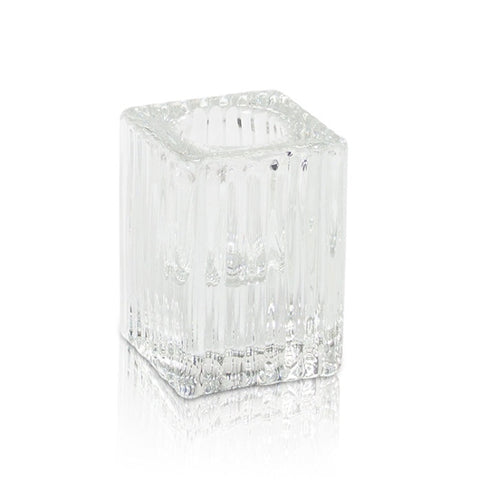 Clear textured square glass candle holder on a white background