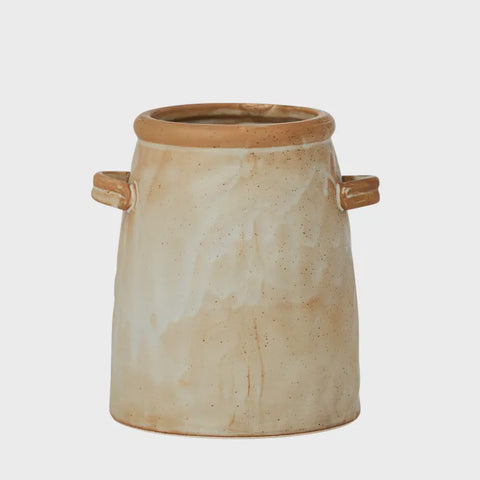 Beige ceramic utensil holder with brown accents on a white background