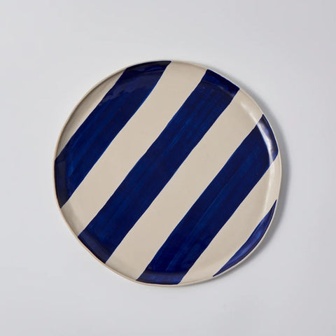 Cabana Stripe Platter in Blue with oranges by Jones & Co held by person in blue shirt 