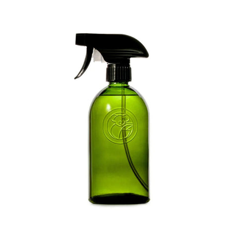 Green spray bottle with black nozzle on a white background
