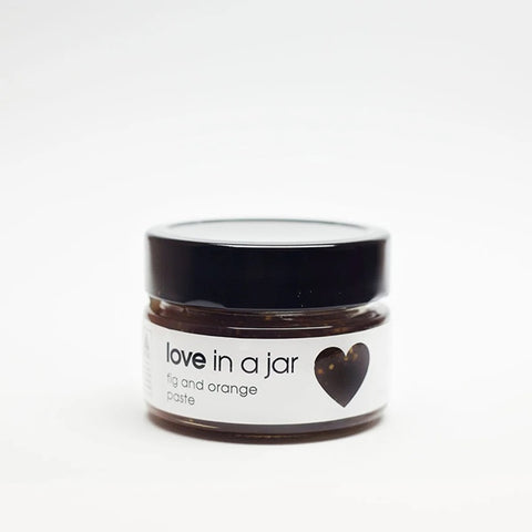 Jar of 'love in a jar' paste with a black lid on a white background