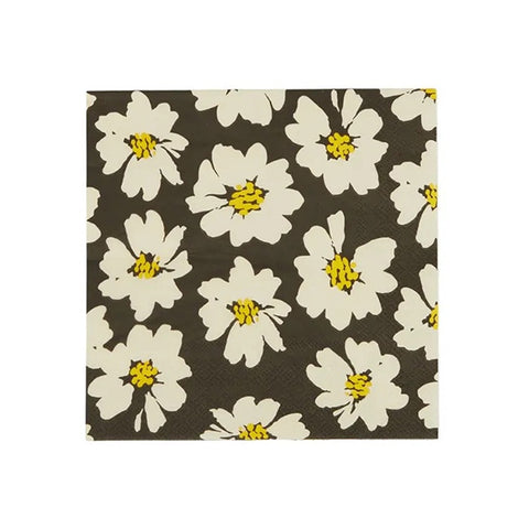 Floral patterned napkin with white flowers and yellow centers on a brown background