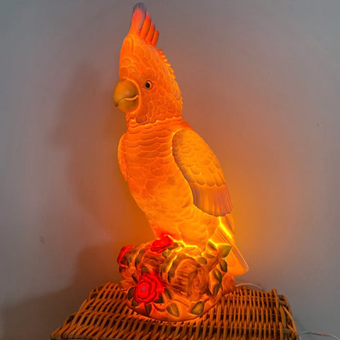 Pink cockatoo nightlight on a wooden box with a blurred background