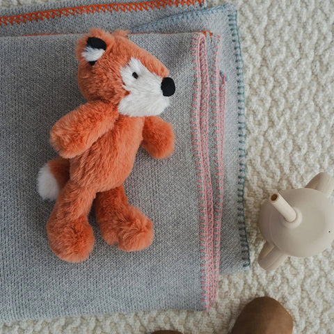 Plush fox toy on a white background