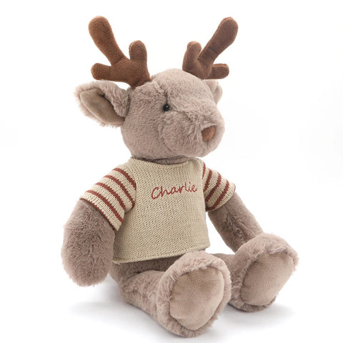 Rudy the Reindeer  by Nana Huchy sits on a gift in front of a Christmas tree