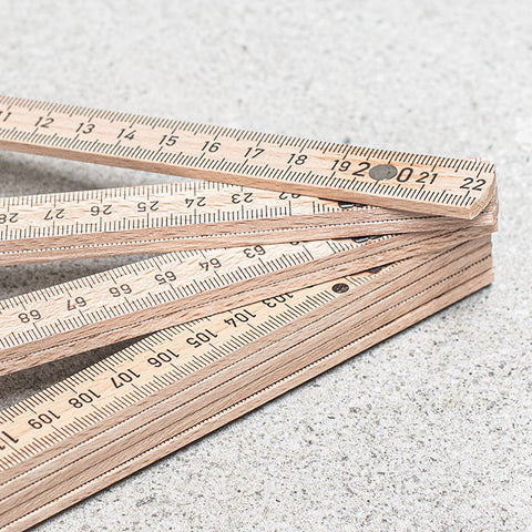 Set of wooden folding rulers on a light gray surface