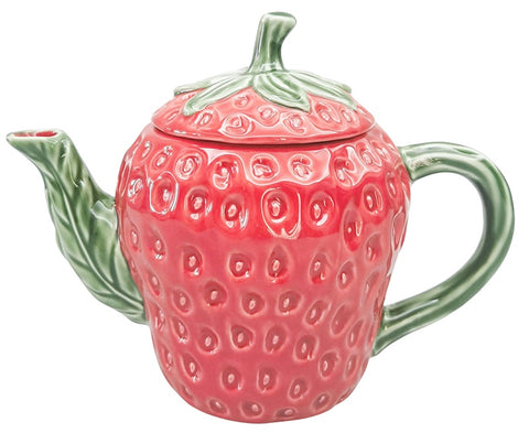 Pink strawberry-shaped teapot with green leaves on a white background
