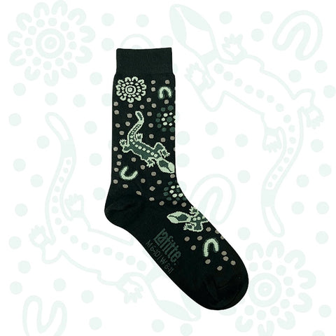 Black sock with green Australian Indigenous designs on a white background