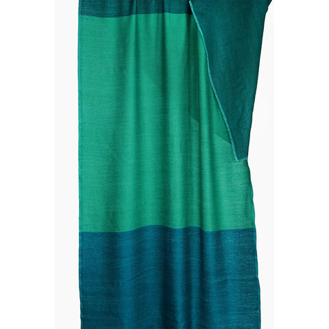 Woman wearing a green and blue scarf on a white background