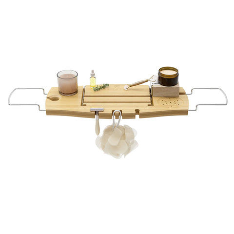 Aquala Bathtub Caddy in Natural by UMBRA on bath with props like a book cup of tea and soap
