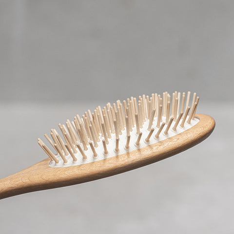Wooden hairbrush on a gray surface