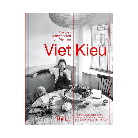 Book cover of 'Viet Kieu' with a black and white photo of a woman and child at a table.