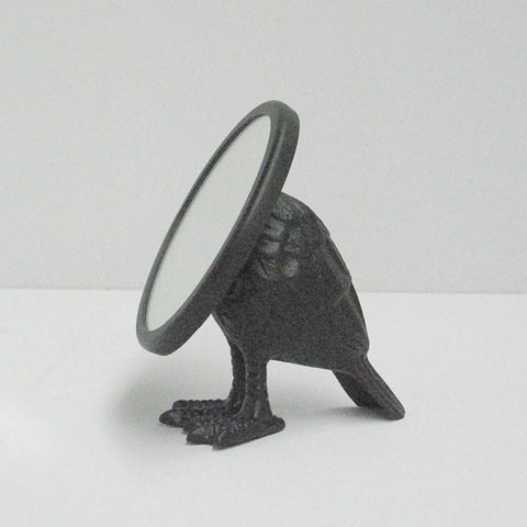 gold shaped mirror on a white background